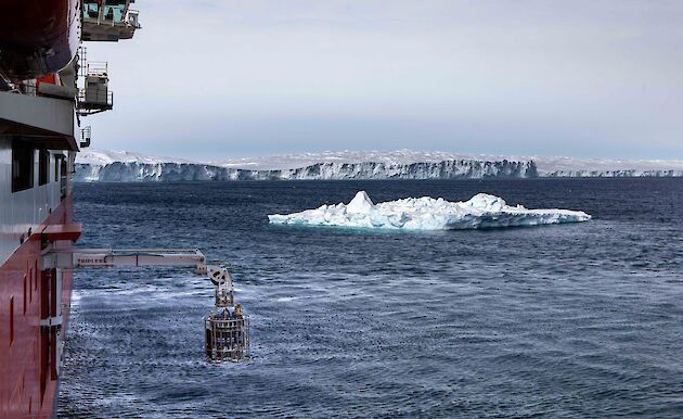 equipment lowered from side of ship into icy water