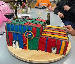 A brightly coloured cake replica of  the building known as 'Rosella' helps an expeditioner celebrate their birthday