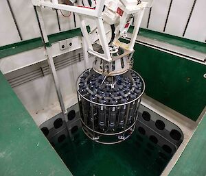 water sampler lowered into pool inside ship