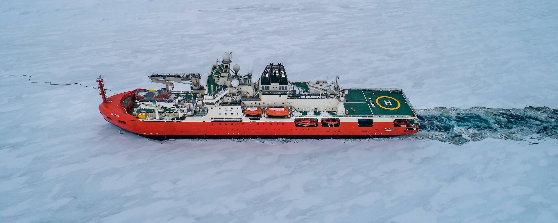 ship pushes through ice-covered sea