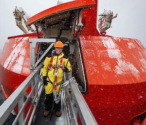 man stands on gantry from bow of ship