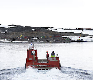 barge named 'Bill Budd' on water with station in background