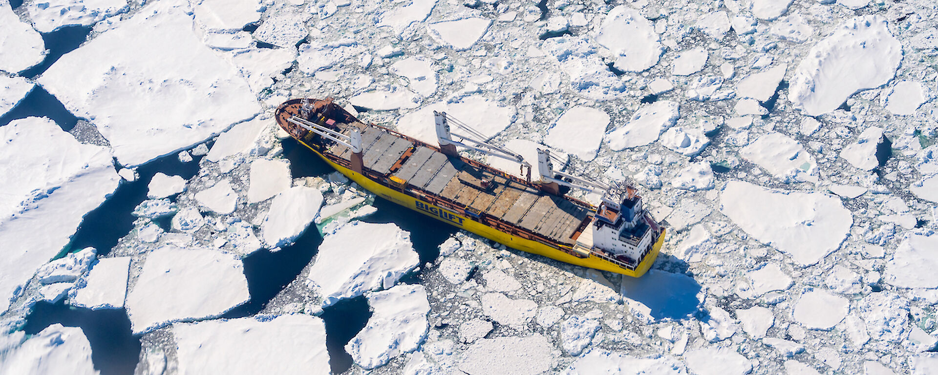 A big ship is surrounded by sea ice