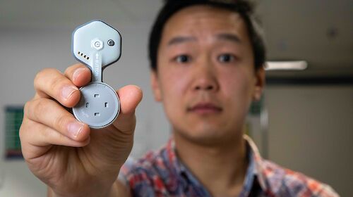 A close up of the BioSticker being held by Andrew