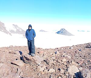 An expeditioner, Billy Merrick, on a saddle above Patterned Lake in the Central Masson range near Mawson