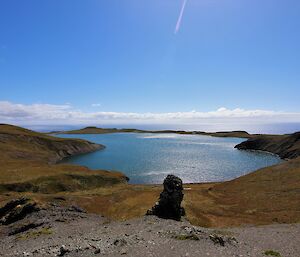 A large lake reflects the sunny day