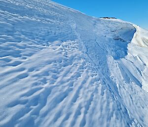 Snow and ice under a sunny blue sky