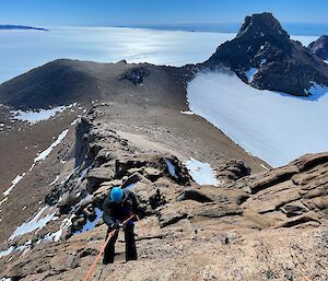 A view out towards the south from the summit of Fang Peak in the David Range near Mawson. Expeditioners in the foreground are abseiling off the summit