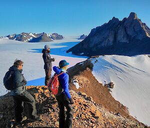 Expeditioners look out from Painted Peak in the North Masson Range on a spectacular Mawson day