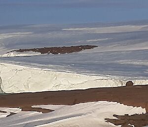 A large chunk of ice near the ice plateau starting to separate,  becoming an ice berg