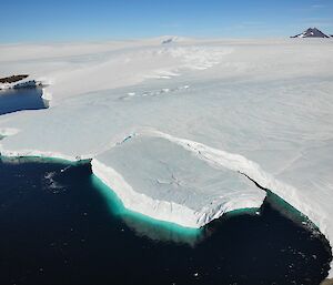 A view from above showing the newly formed ice berg near the cliff edge at Mawson