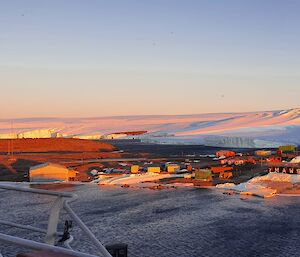 Sunset shot taken from a ship overlooking the station and surrounding snow and ice