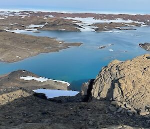 Aerial view of the Vestfold Hills showing bare hills and a blue lake