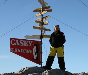 A woman stands next to a sign that says Casey
