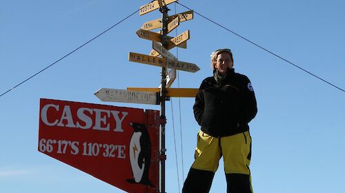 A woman stands next to a sign that says Casey