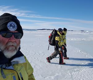 Three expeditioners walking on the sea ice