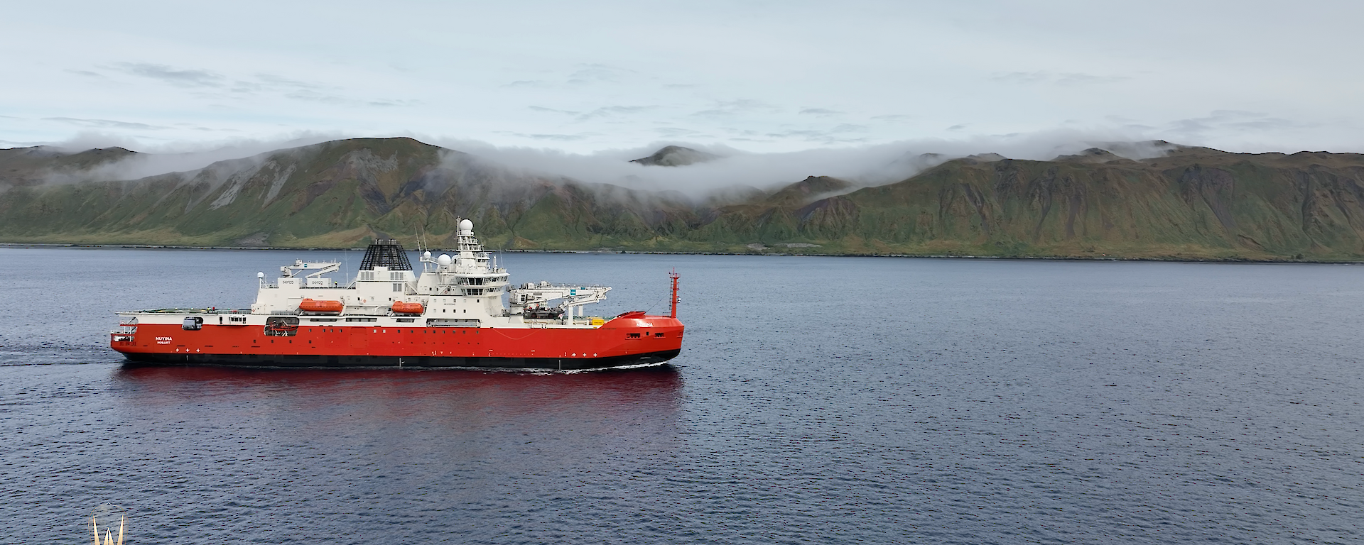 Australia's ice breaker RSV Nuyina sailing past Macquarie Island covered in low cloud