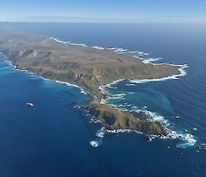 Aerial view of Macquarie Island with RSV Nuyina moored in a bay