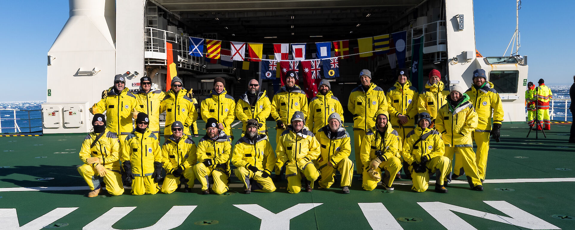 Picture showing the new team on the helideck of the new ship Nuyina