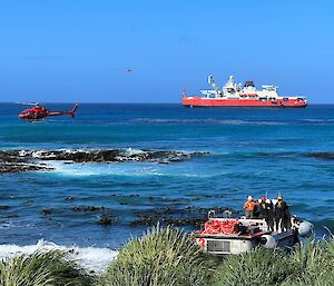 Helicopters and LARCs transport goods to station