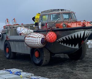 A LARC - an amphibious vehicle heads to the ship for more cargo