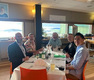 A group of men at a dinner table for a formal dinner