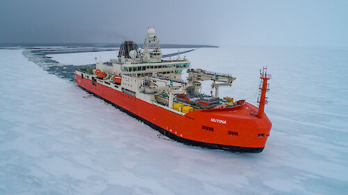 An ice breaker pushes through ice