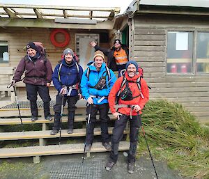 Group of Expeditioners in front of the main mess ready to depart station
