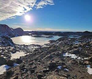 Rocky ground looking over a lake and blue skies