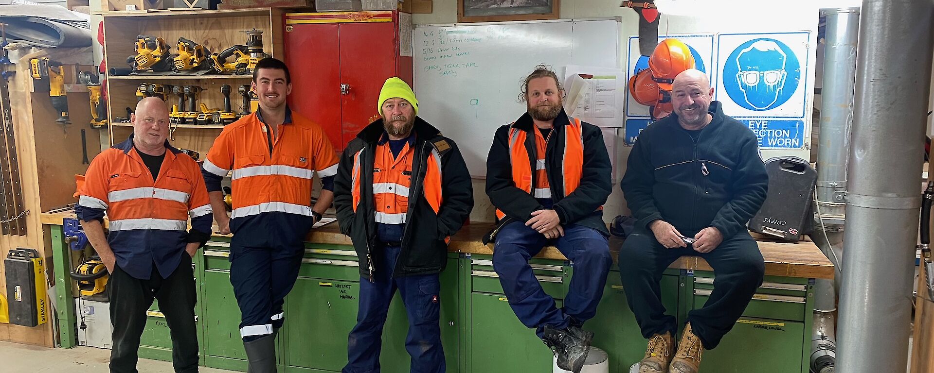 Trades group in workshop in hi viz gear