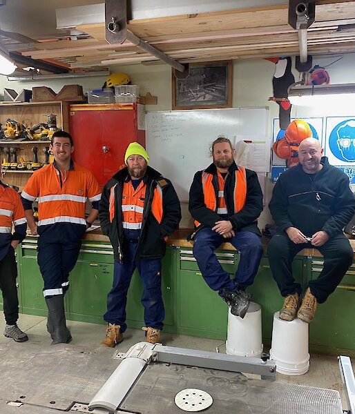 Trades group in workshop in hi viz gear