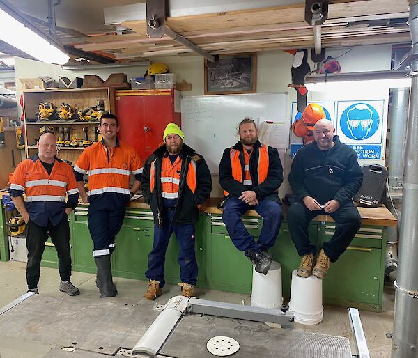 Trades group in workshop in hi viz gear