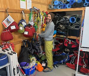 Expeditioner in field store that contains hiking gear