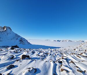 On top of the plateau after snowfall under a blue sky