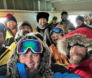 A group of expeditioners gathered around for a photo