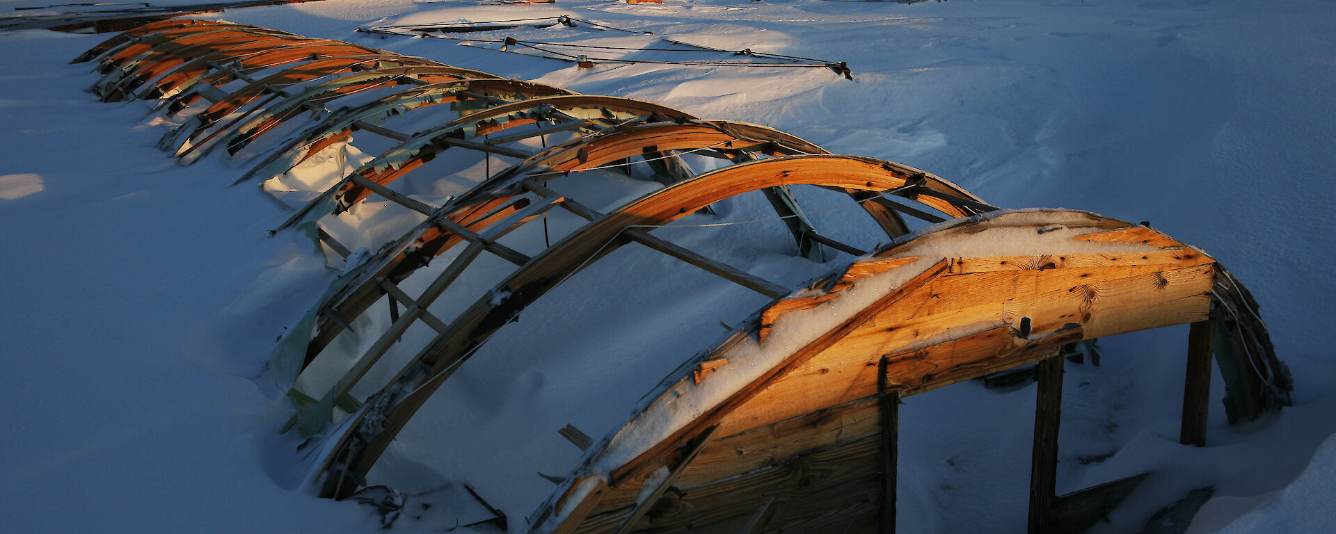 The rusted frame of building covered in snow