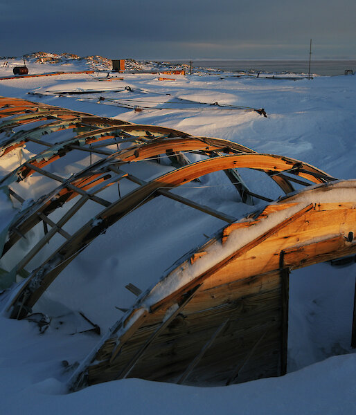 The rusted frame of building covered in snow