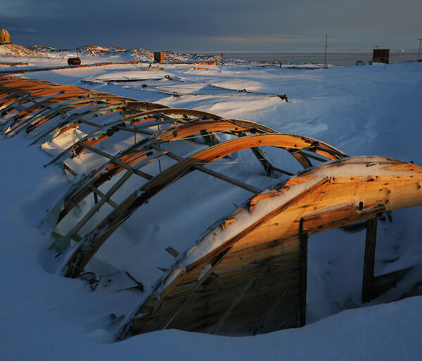 The rusted frame of building covered in snow