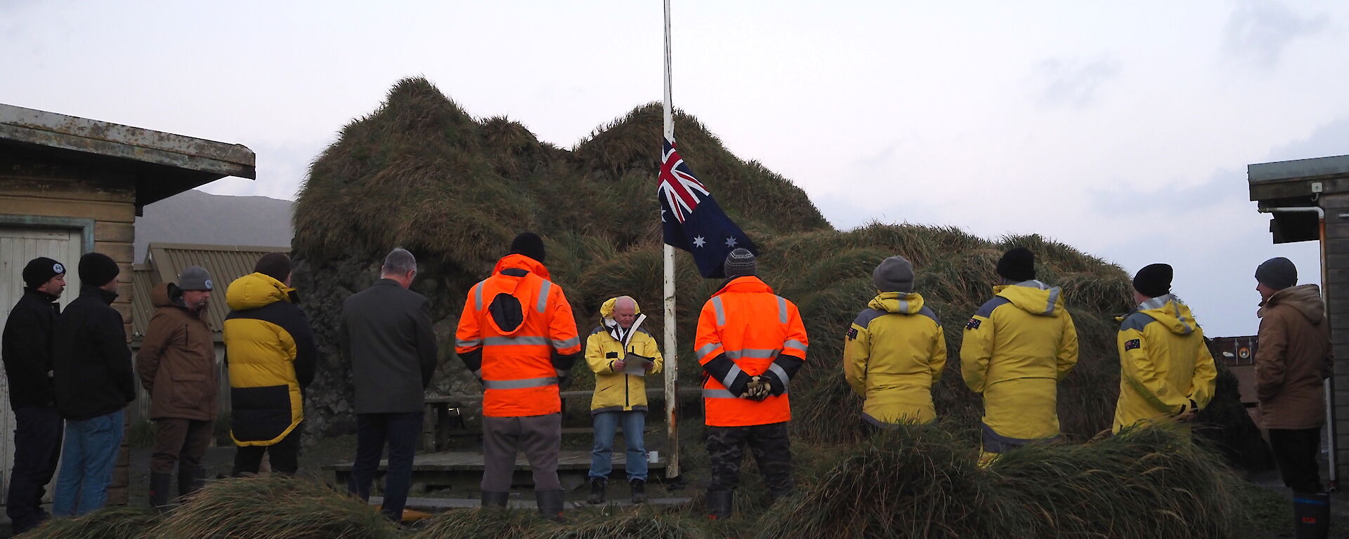 Station members gather around a flag pole to hear Station Leader deliver the Anzac Day speech.