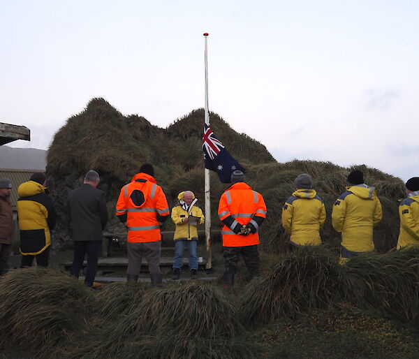 Station members gather around a flag pole to hear Station Leader deliver the Anzac Day speech.