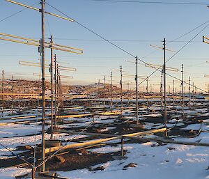 An array of antennas sitting in snow and rocks