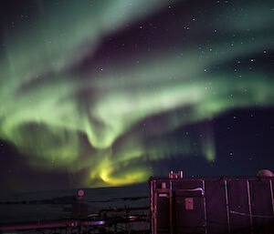 Very bright active aurora in green yellow and pink over the hydroponics shed