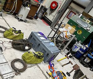 Collection of Hägglunds recovery equipment laid out on workshop floor including winches, ropes, shovels, crow bars and ice anchors
