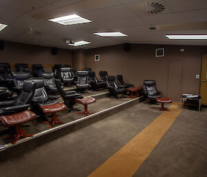 A small cinema with around 20 recliner chairs