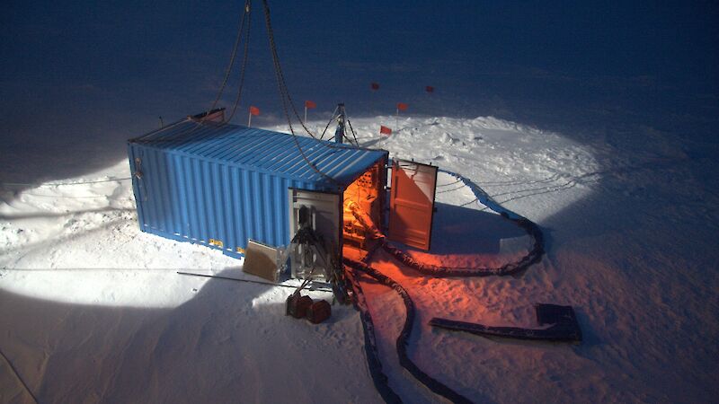 A krill pump inside a blue shipping container on the ice