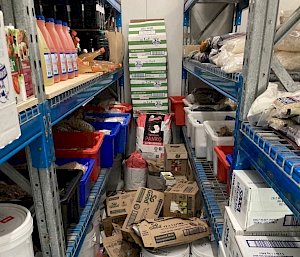 Shelves with boxes of food that have tumbled off