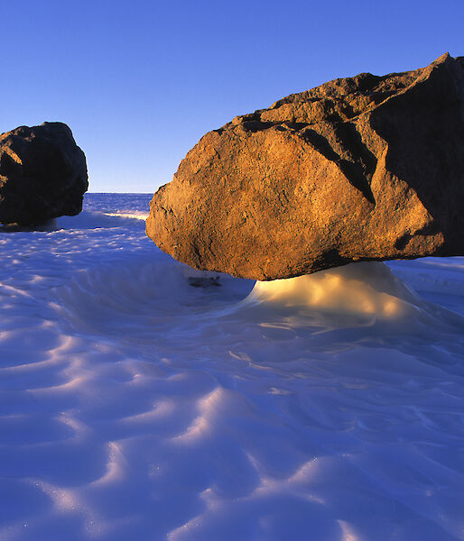 Three large rocks held aloft by ice pillars.