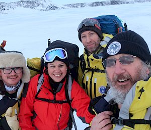A group of expeditioners close up photo on the sea ice