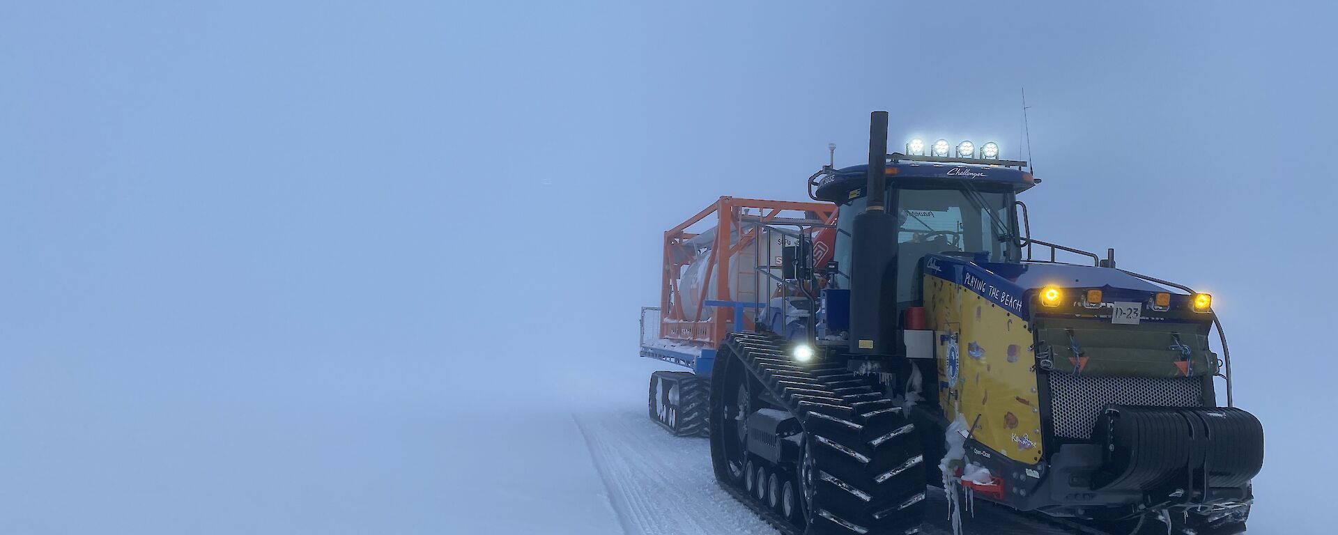 A Challenger tractor towing a flatbed. The cloudy sky appears to merge seamlessly with the snowy ground