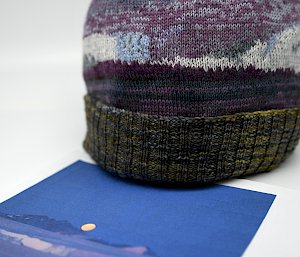 A photo of an icy landscape next to beanie with has used the image in its design